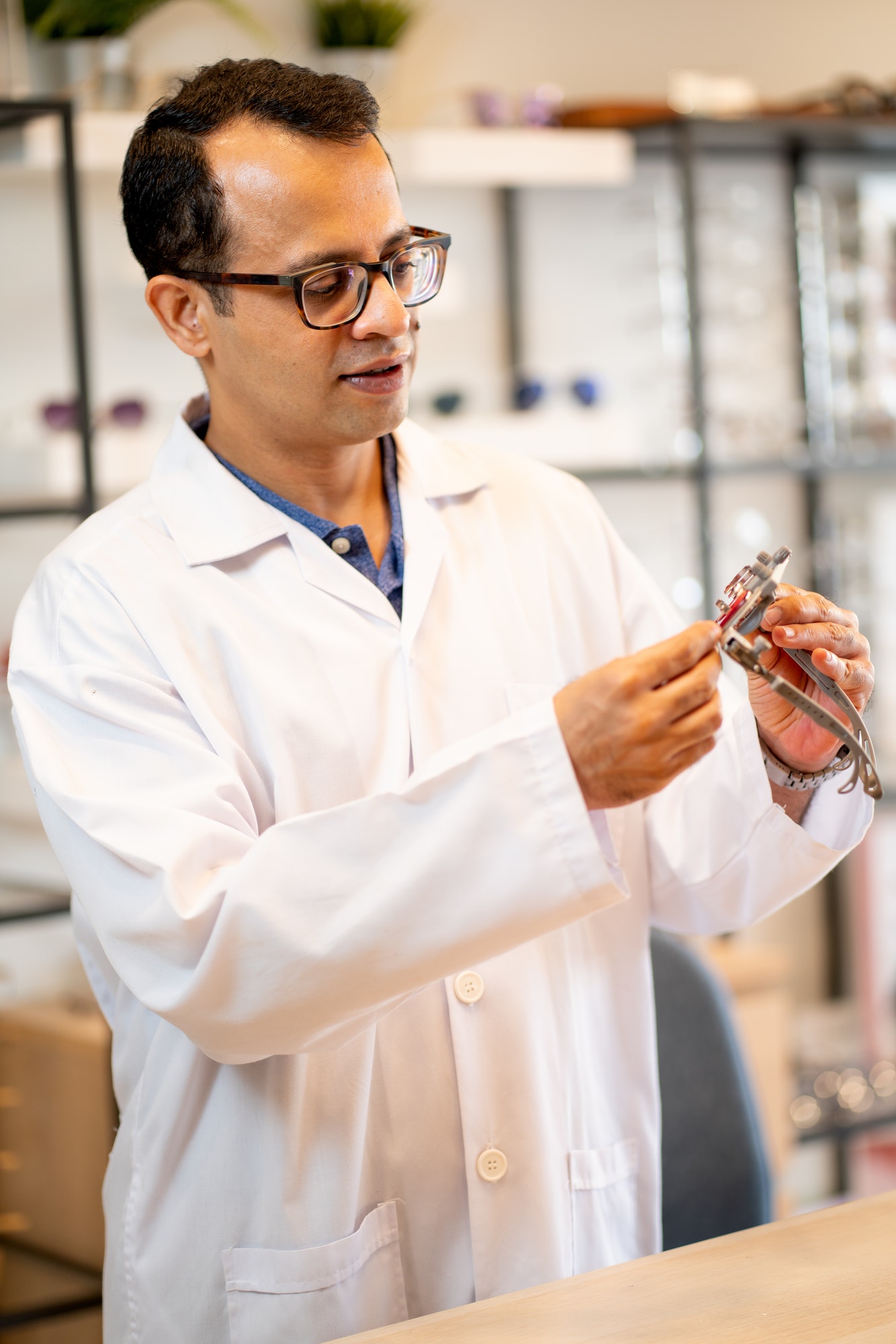ophthalmologist or optical staff hold special glasses for testing and check the function